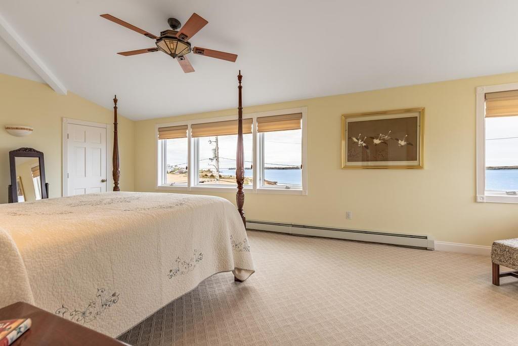 79 Clark Road Ipswich, MA 01938 - Photo 26 of 35 a spacious bedroom with a bed a dresser and a window