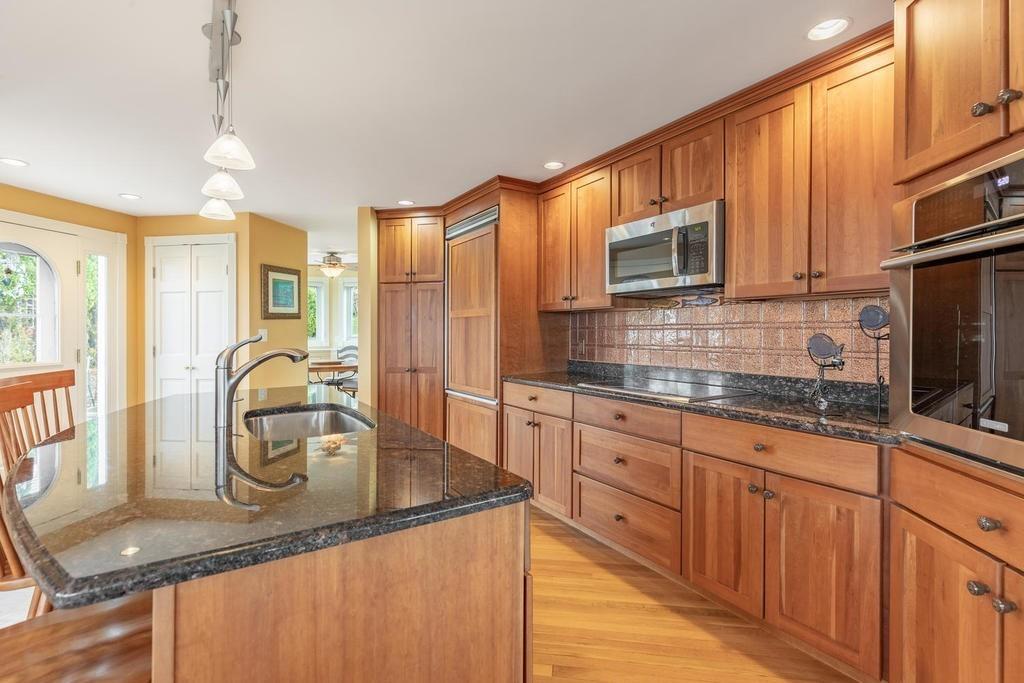 79 Clark Road Ipswich, MA 01938 - Photo 9 of 35 a kitchen with stainless steel appliances granite countertop a sink a stove counter space and cabinets