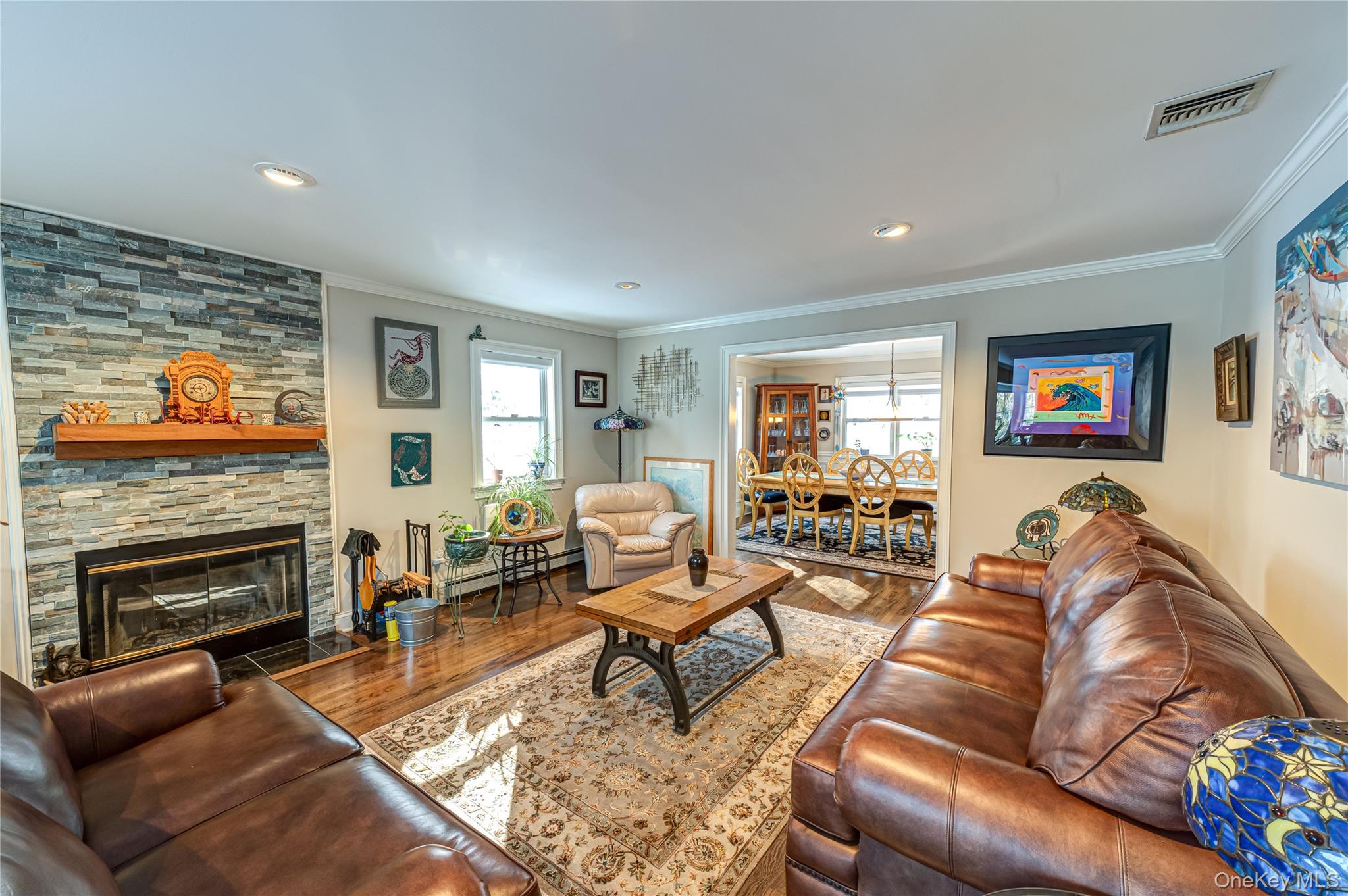 6 Sandy Hollow Road Centerport, NY 11768 - Photo 11 of 41 a living room with furniture flat screen tv and a fireplace
