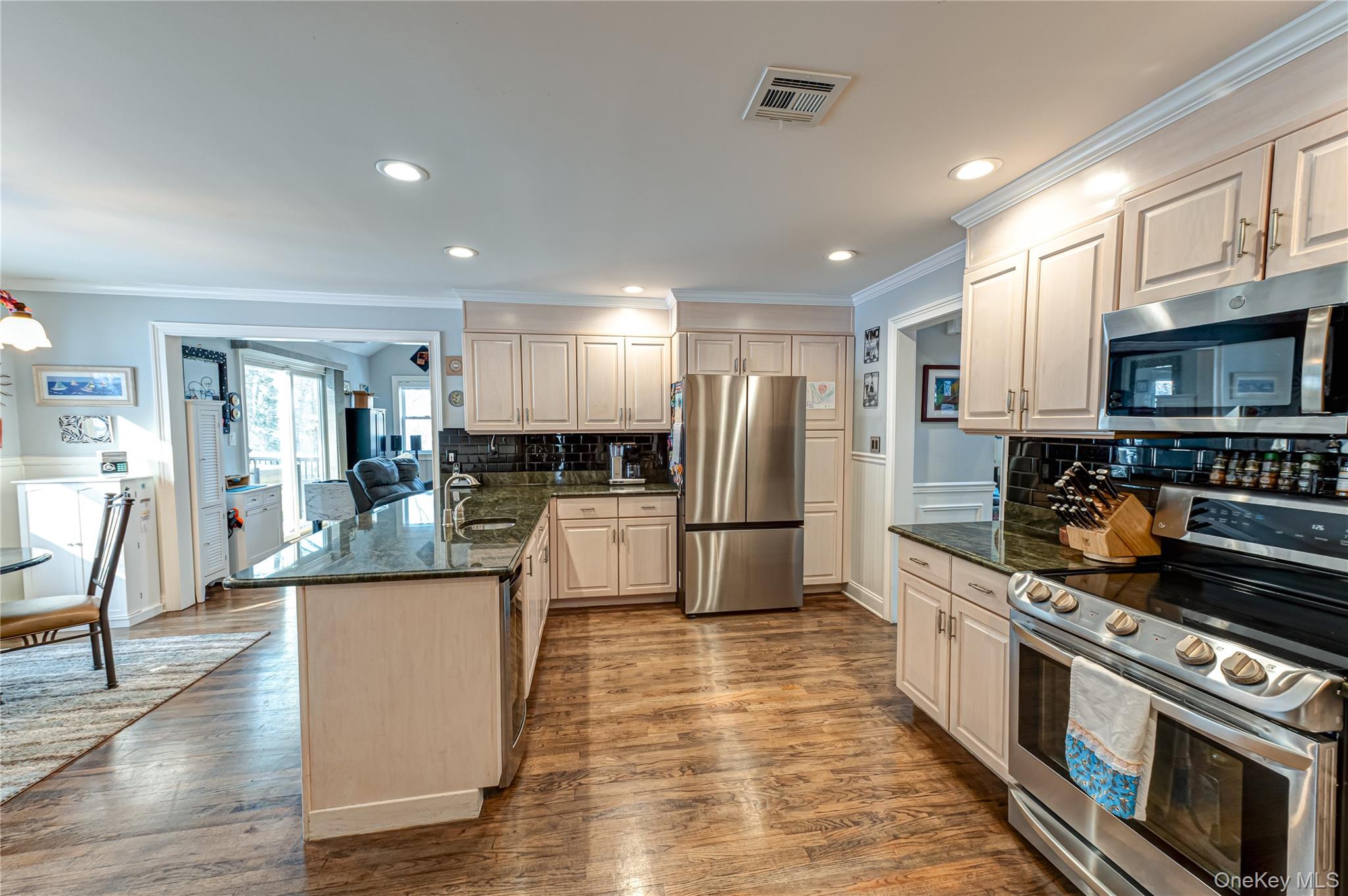 6 Sandy Hollow Road Centerport, NY 11768 - Photo 17 of 41 a kitchen with stainless steel appliances kitchen island granite countertop a stove a sink a refrigerator and cabinets
