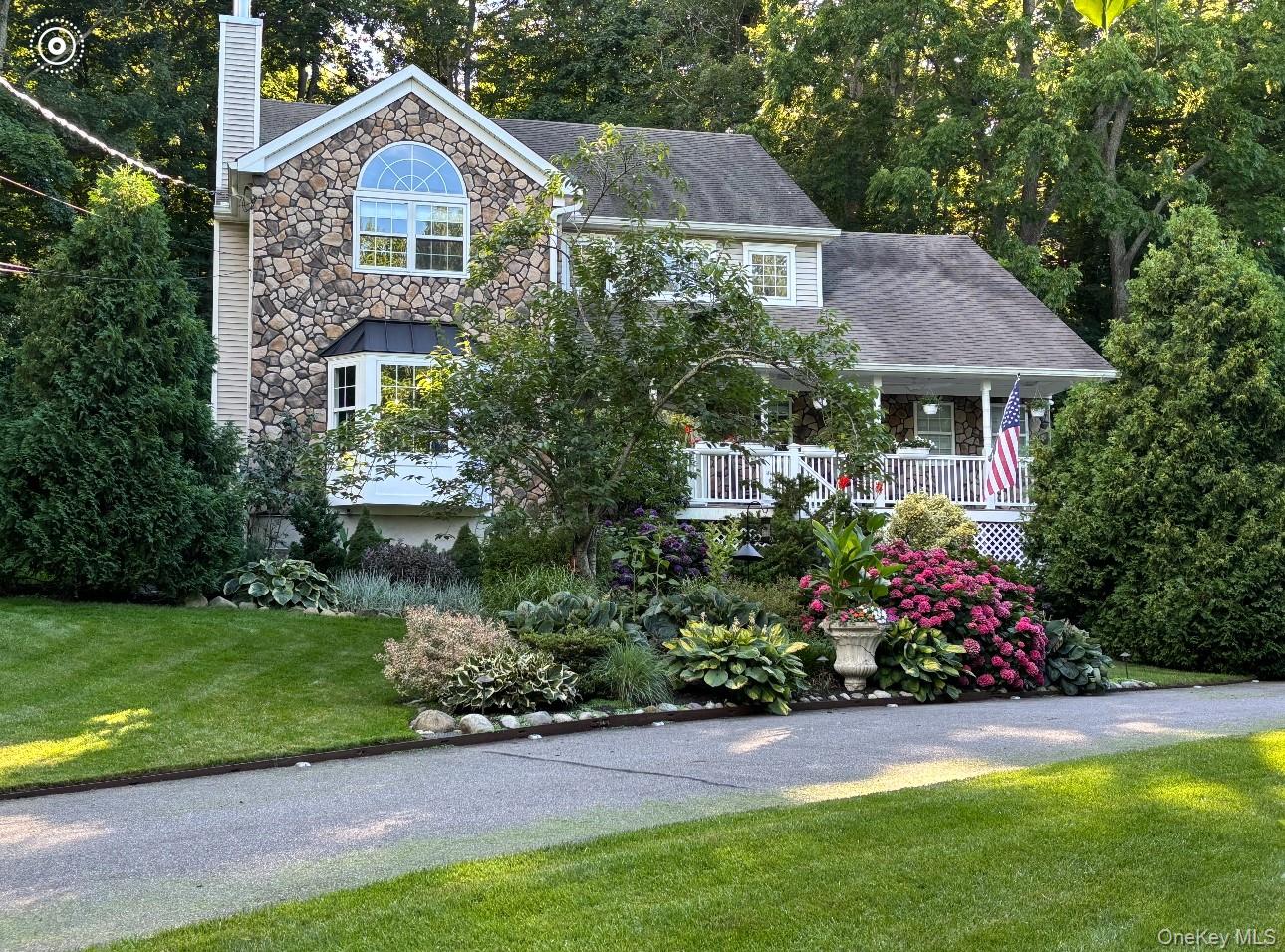 6 Sandy Hollow Road Centerport, NY 11768 - Photo 2 of 41 a front view of a house with a garden