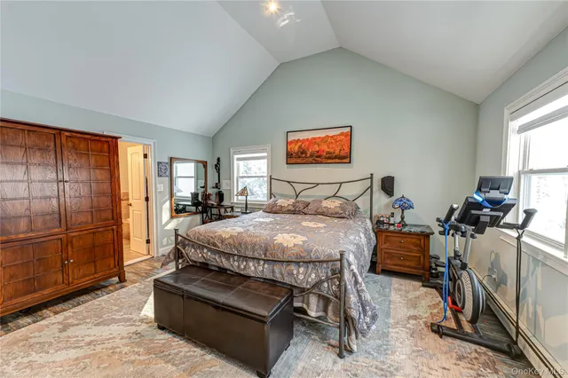 a bedroom with furniture and a flat screen tv