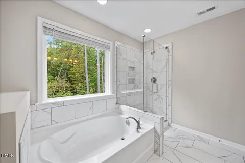 a white bath tub sitting next to a window