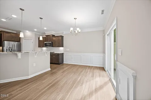 a view of a kitchen with a sink wooden floor and a kitchen
