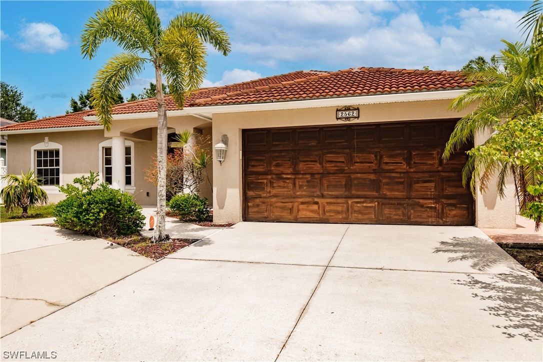a front view of a house with a yard and garage