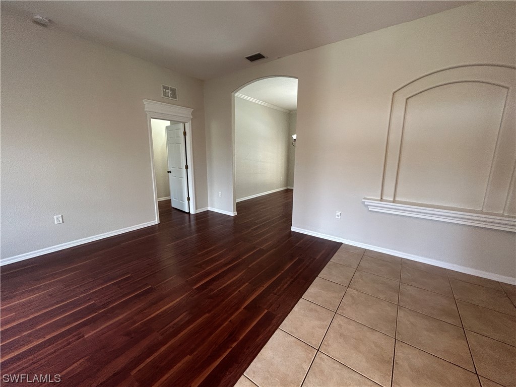 2562 Nature Pointe Loop Fort Myers, FL 33905 - Photo 12 of 44 a view of an empty room with wooden floor and a mirror