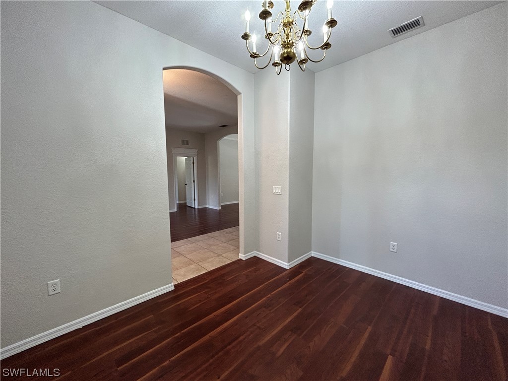 2562 Nature Pointe Loop Fort Myers, FL 33905 - Photo 14 of 44 wooden floor in an empty room with a mirror