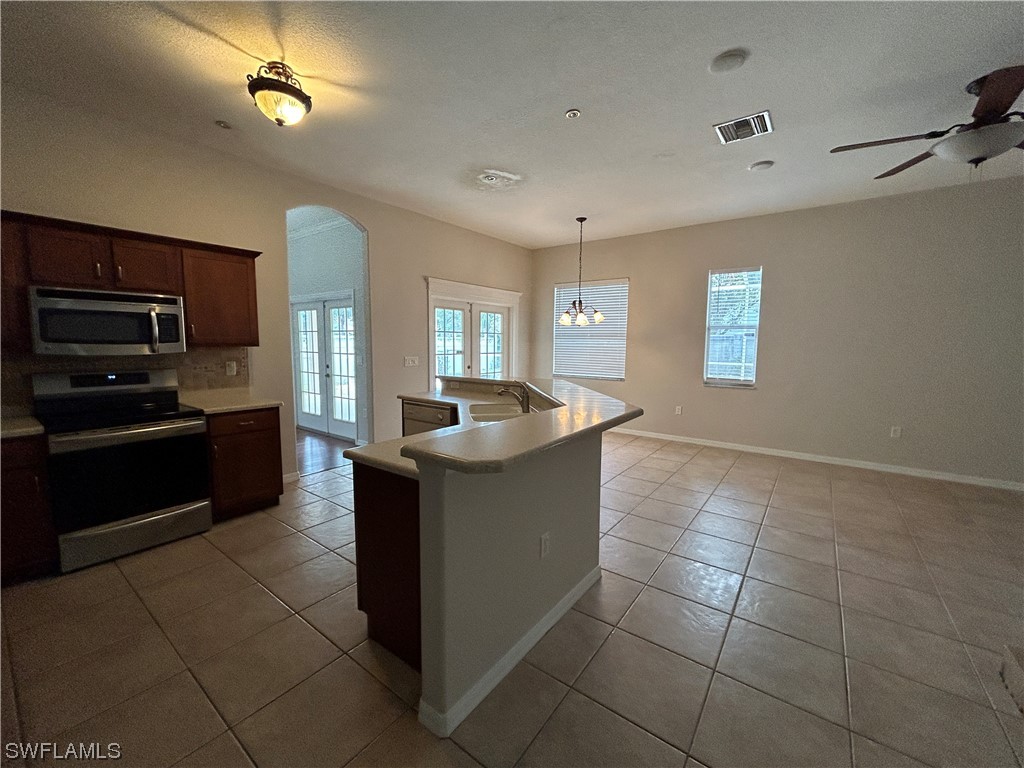 2562 Nature Pointe Loop Fort Myers, FL 33905 - Photo 19 of 44 a large kitchen with stainless steel appliances granite countertop a sink and cabinets