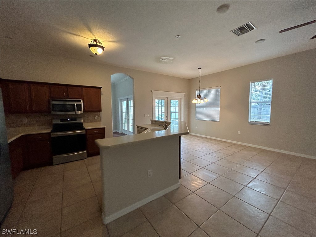 2562 Nature Pointe Loop Fort Myers, FL 33905 - Photo 20 of 44 a kitchen with stainless steel appliances granite countertop a refrigerator and a stove top oven
