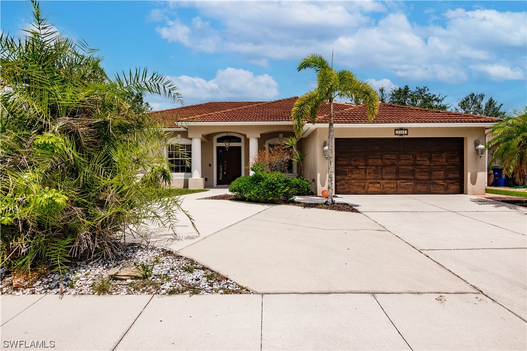 2562 Nature Pointe Loop Fort Myers, FL 33905 - Photo 2 of 44 a front view of a house with yard