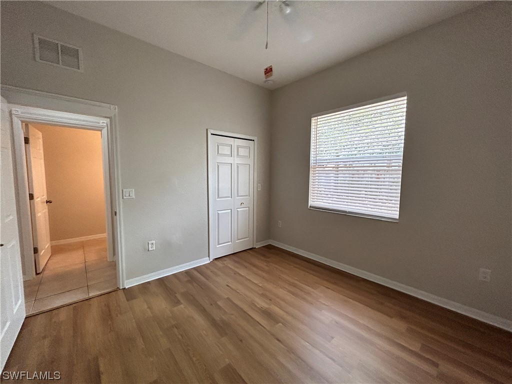 2562 Nature Pointe Loop Fort Myers, FL 33905 - Photo 25 of 44 a view of an empty room with wooden floor and a window