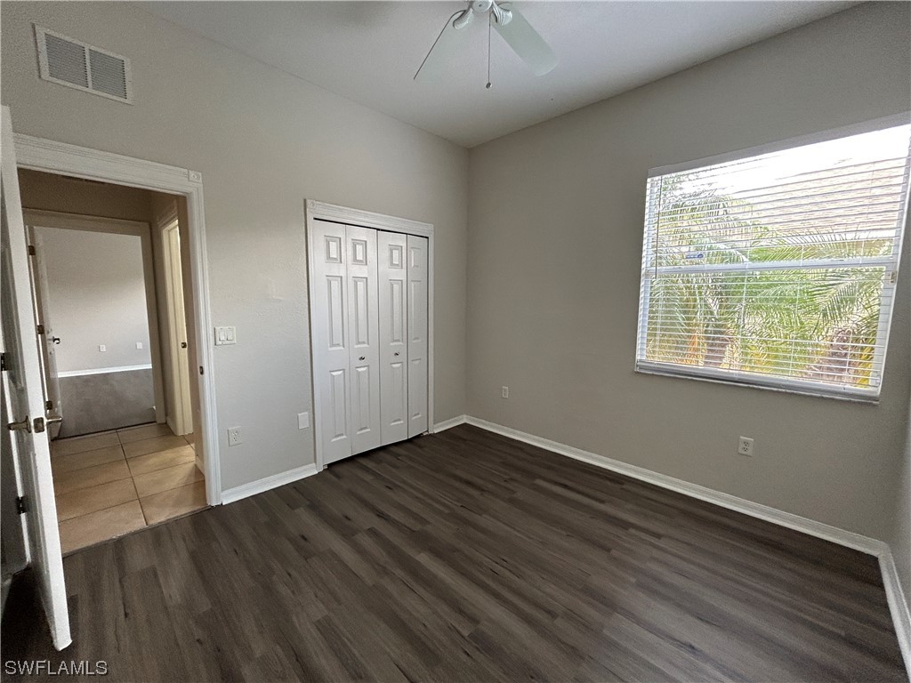 2562 Nature Pointe Loop Fort Myers, FL 33905 - Photo 29 of 44 an empty room with wooden floor and windows