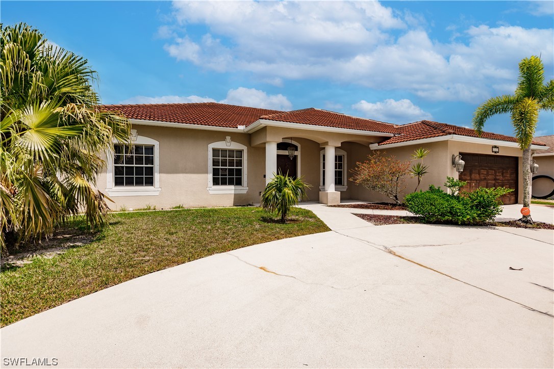 2562 Nature Pointe Loop Fort Myers, FL 33905 - Photo 3 of 44 a front view of a house with garden