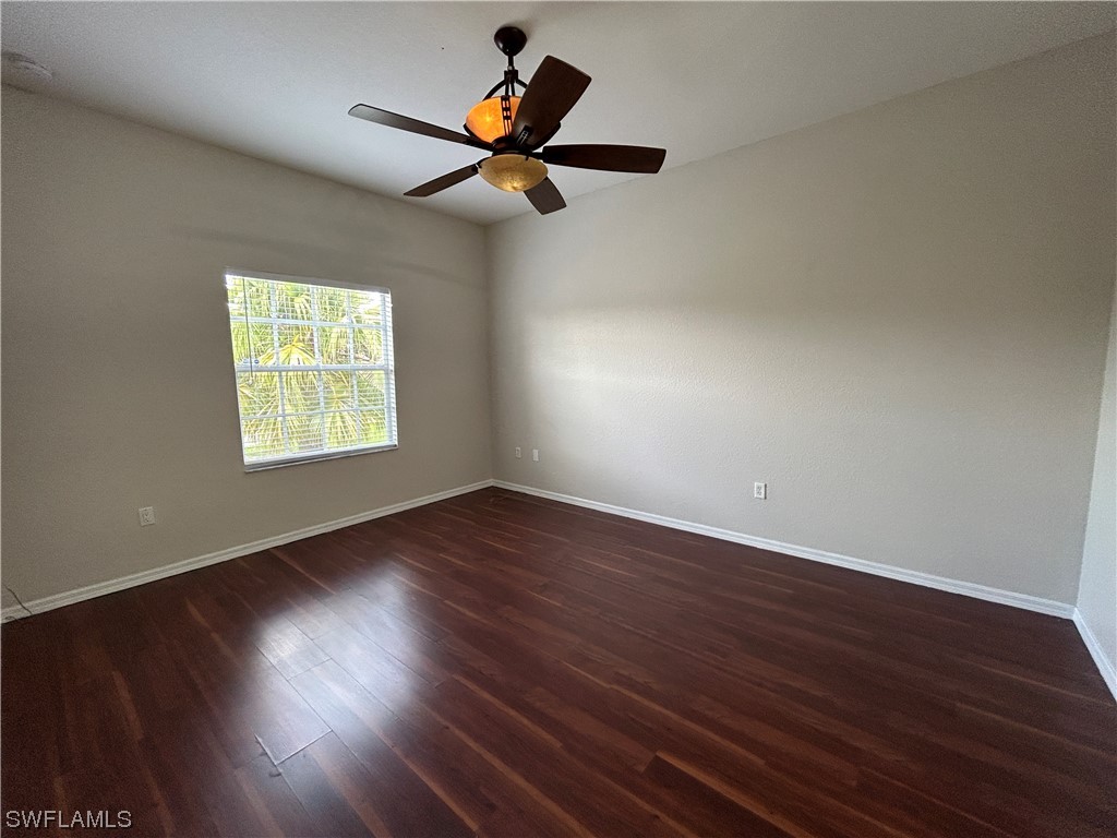 2562 Nature Pointe Loop Fort Myers, FL 33905 - Photo 35 of 44 a view of an empty room with wooden floor and a window