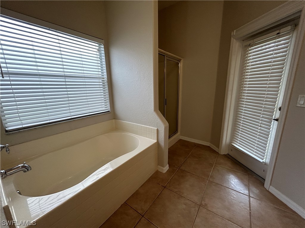2562 Nature Pointe Loop Fort Myers, FL 33905 - Photo 40 of 44 a bathroom with a bathtub and a shower