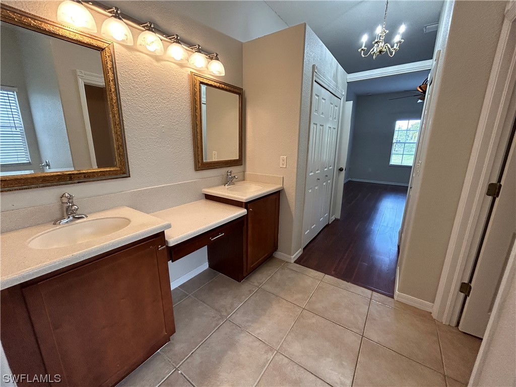 2562 Nature Pointe Loop Fort Myers, FL 33905 - Photo 42 of 44 a bathroom with a sink a mirror and a vanity