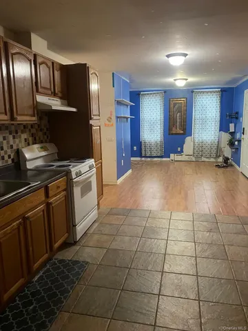 a kitchen with stainless steel appliances a sink stove and cabinets