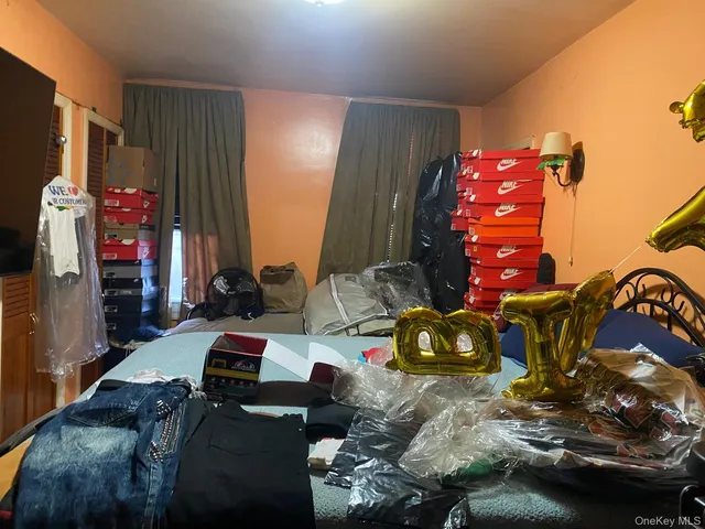 a bedroom with a bed closet and a window