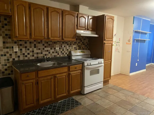 a kitchen with stainless steel appliances granite countertop a stove a refrigerator and a sink