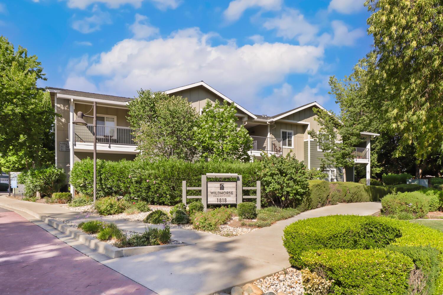 1818 Moore Boulevard, Unit 201 Davis, CA 95618 - Photo 1 of 40 a front view of a house with garden