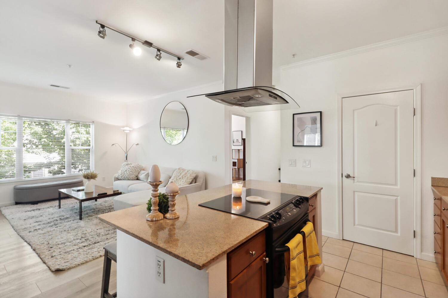 1818 Moore Boulevard, Unit 201 Davis, CA 95618 - Photo 12 of 40 a living room with furniture and a large window
