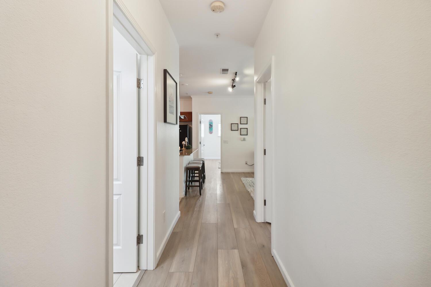 1818 Moore Boulevard, Unit 201 Davis, CA 95618 - Photo 13 of 40 a view of a hallway with wooden floor