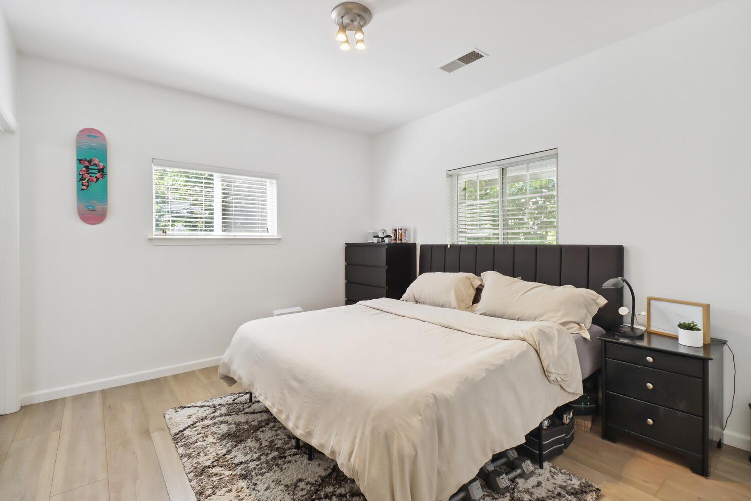 1818 Moore Boulevard, Unit 201 Davis, CA 95618 - Photo 14 of 40 a bedroom with a bed and a window