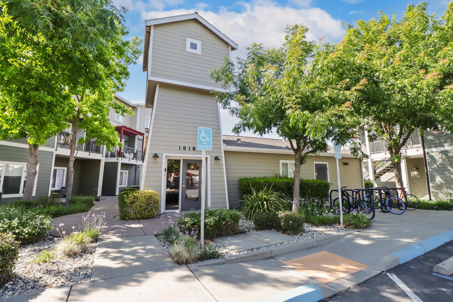 1818 Moore Boulevard, Unit 201 Davis, CA 95618 - Photo 26 of 40 a view of a house with brick walls plants and large tree