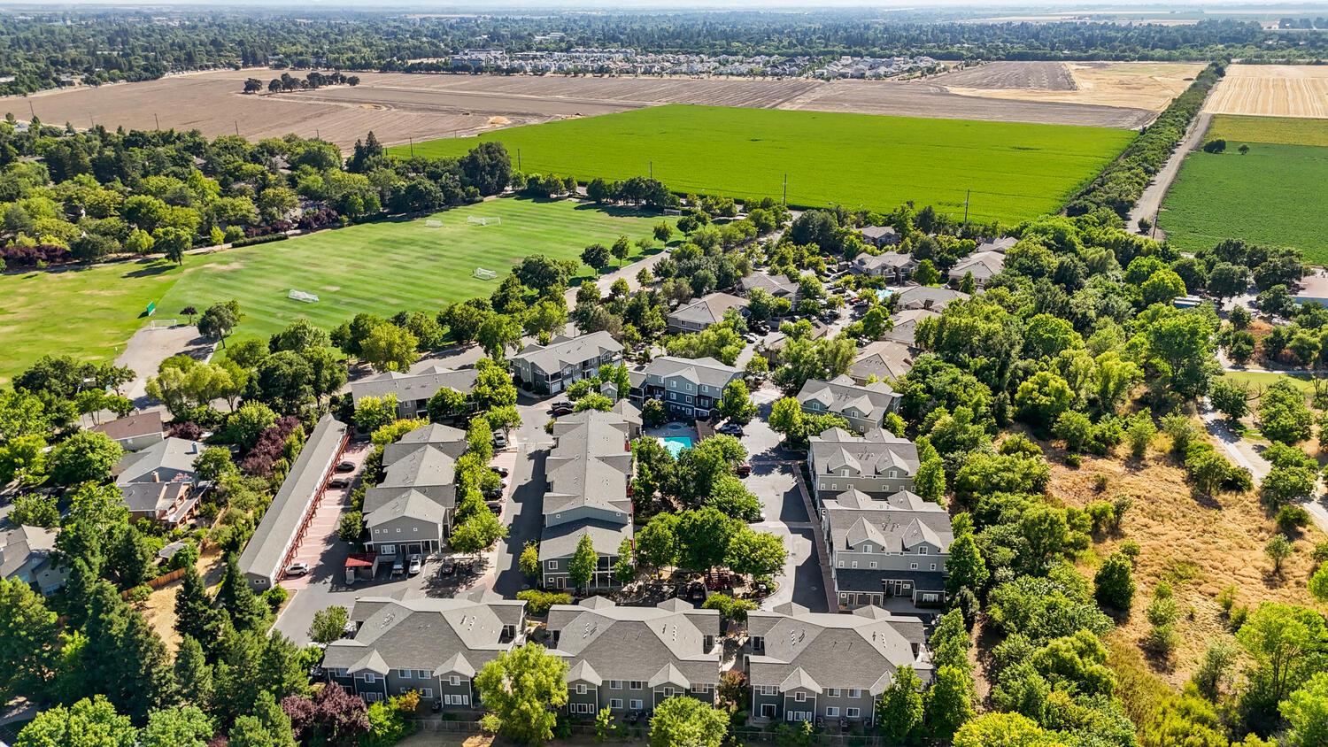 1818 Moore Boulevard, Unit 201 Davis, CA 95618 - Photo 37 of 40 an aerial view of a houses with outdoor space and swimming pool