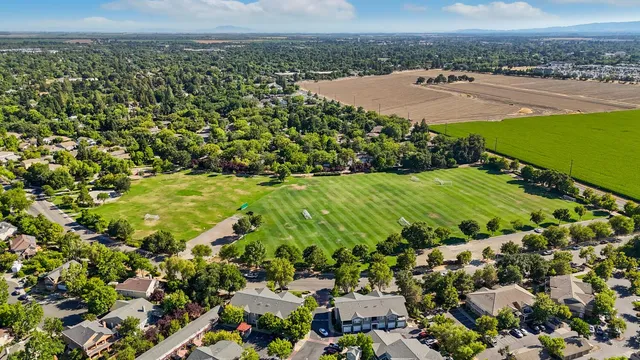 an aerial view of a houses with a garden
