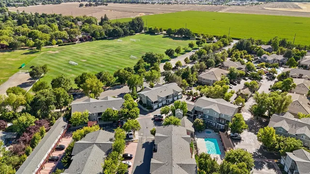 an aerial view of a house with a yard