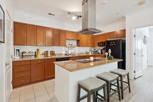 a kitchen with a sink a stove and chairs