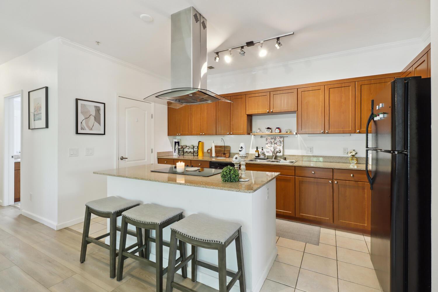 1818 Moore Boulevard, Unit 201 Davis, CA 95618 - Photo 10 of 40 a kitchen with granite countertop a sink appliances cabinets and furniture