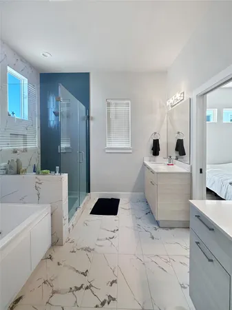 a bathroom with a bathtub sink and mirror