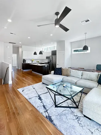 a living room with furniture and kitchen view