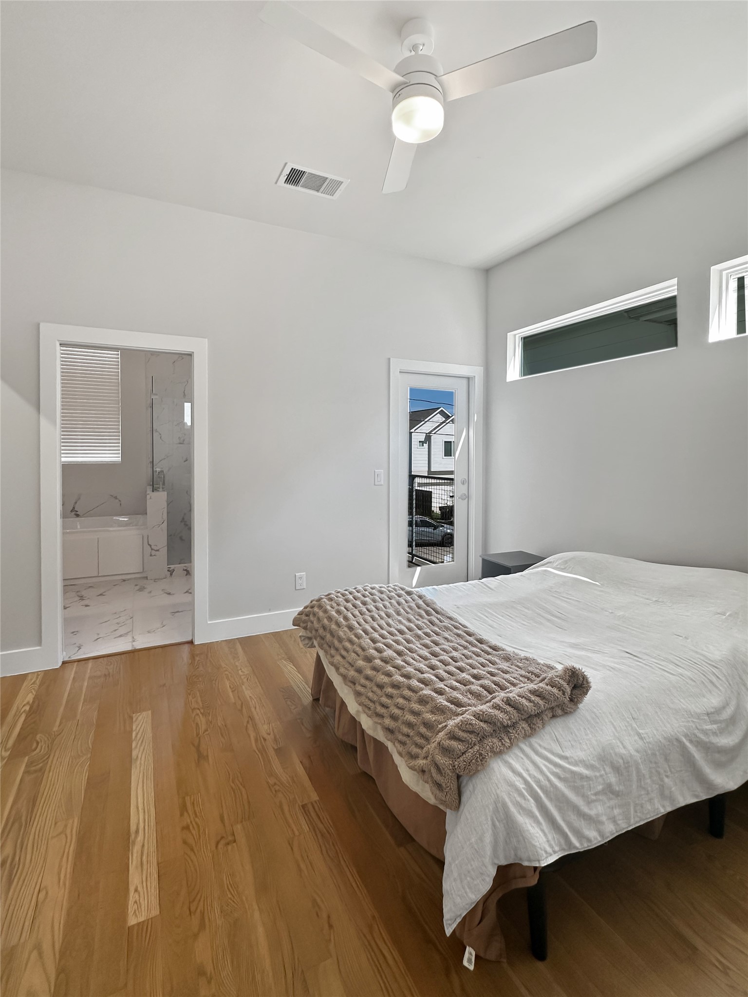 4702 Oats Street, Unit B Houston, TX 77020 - Photo 8 of 20 a bedroom with a bed and wooden floor