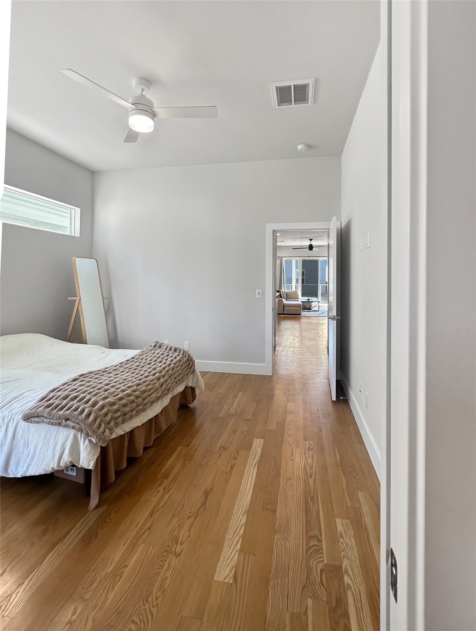 4702 Oats Street, Unit B Houston, TX 77020 - Photo 10 of 20 a bedroom with a bed and wooden floor