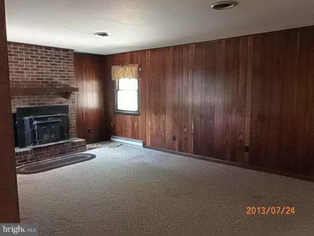27907 Oriole Road Princess Anne, MD 21853 - Photo 2 of 4 an empty room with windows and fireplace