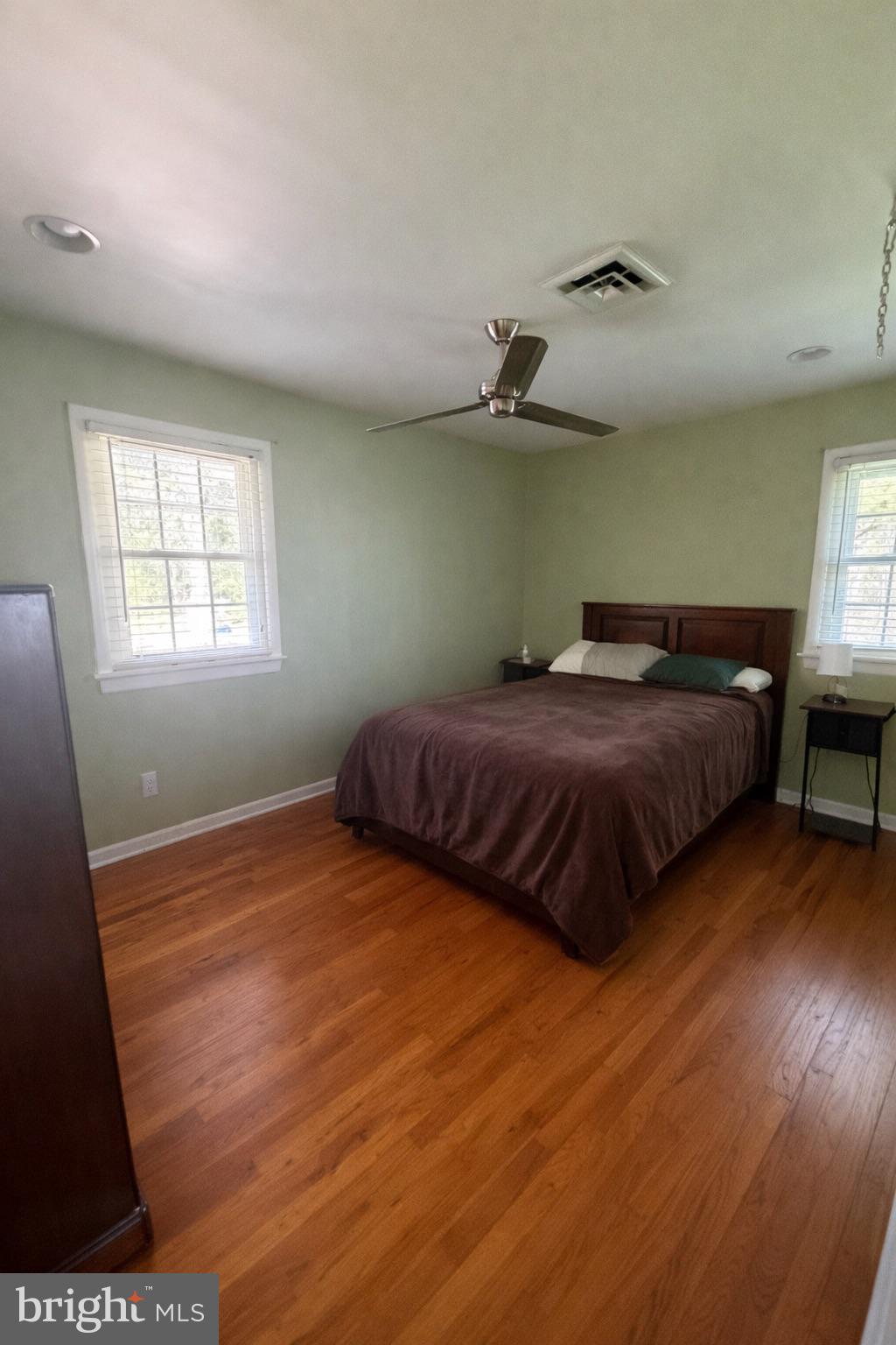 5020 Bucktown Road Cambridge, MD 21613 - Photo 7 of 20 a bedroom with a bed and wooden floor