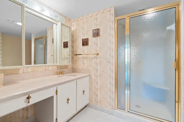 a bathroom with a shower sink and mirror