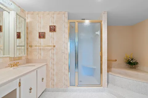 a bathroom with a shower sink and mirror