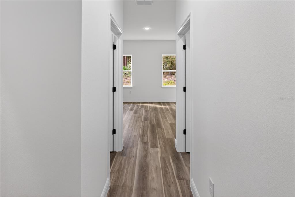 9066 North Akola Way Citrus Springs, FL 34434 - Photo 11 of 32 a view of hallway with wooden floor