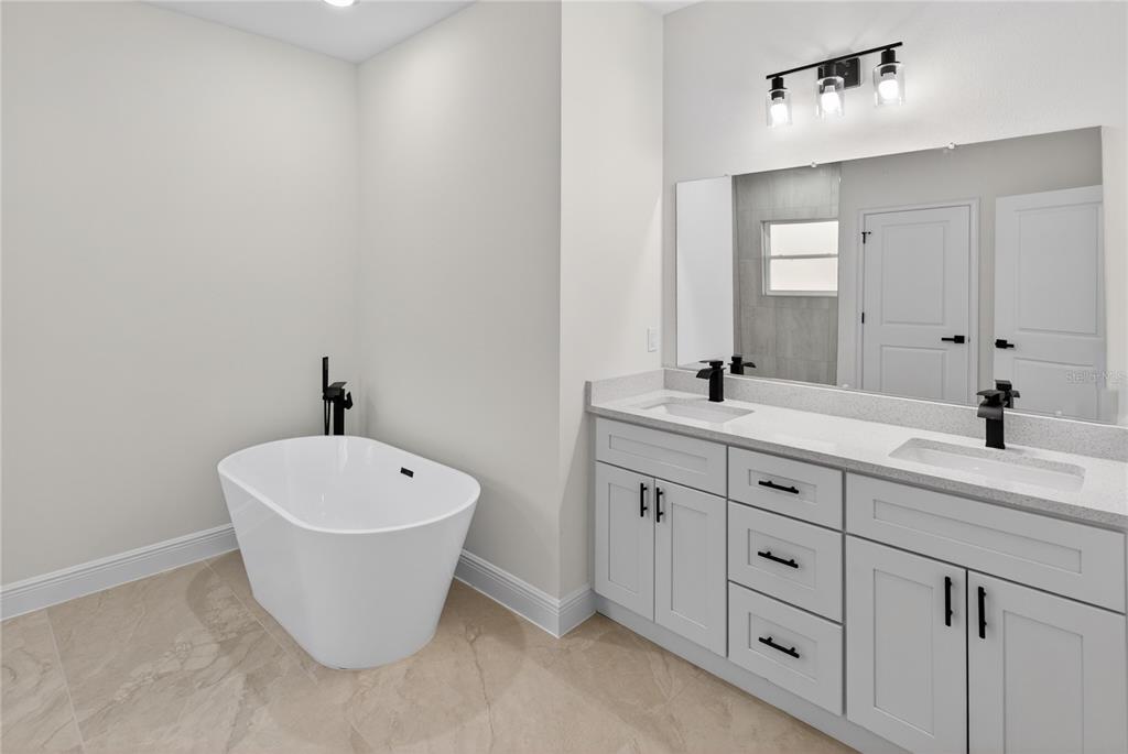 9066 North Akola Way Citrus Springs, FL 34434 - Photo 16 of 32 a spacious bathroom with a double vanity sink and a bathtub