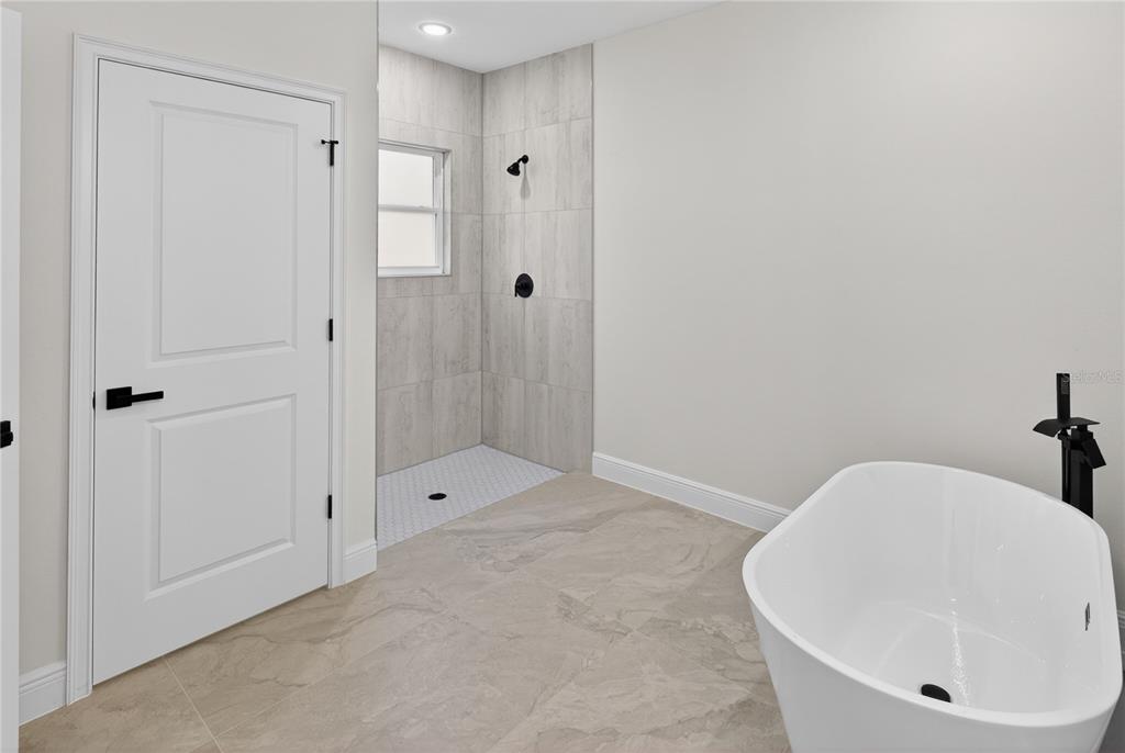 9066 North Akola Way Citrus Springs, FL 34434 - Photo 17 of 32 a bathroom with a bathtub and shower