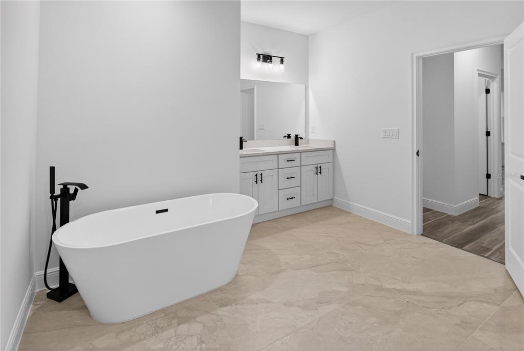 9066 North Akola Way Citrus Springs, FL 34434 - Photo 18 of 32 a spacious bathroom with a tub sink and mirror