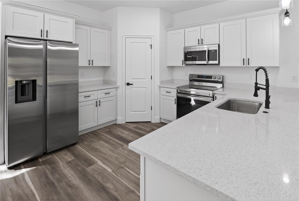 9066 North Akola Way Citrus Springs, FL 34434 - Photo 20 of 32 a kitchen with stainless steel appliances a refrigerator sink and microwave