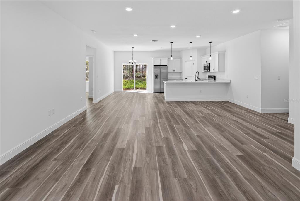 9066 North Akola Way Citrus Springs, FL 34434 - Photo 25 of 32 a view of a kitchen with wooden floor and windows