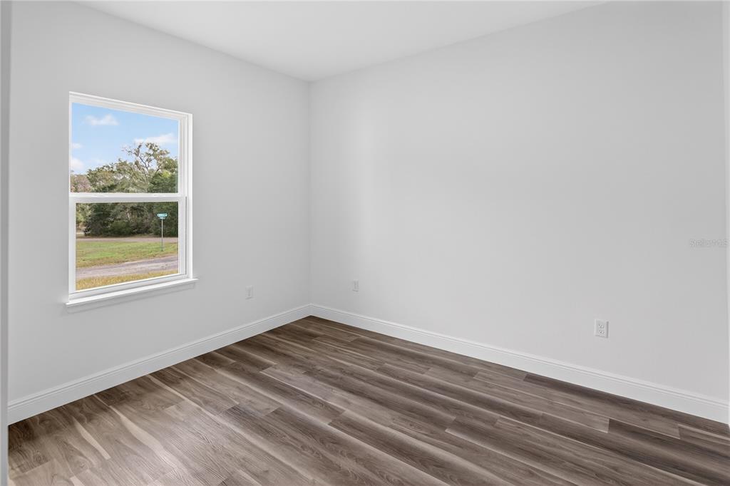 9066 North Akola Way Citrus Springs, FL 34434 - Photo 3 of 32 a room with a wooden floor and a window