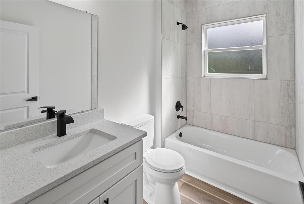 9066 North Akola Way Citrus Springs, FL 34434 - Photo 9 of 32 a bathroom with a granite countertop sink toilet and bathtub
