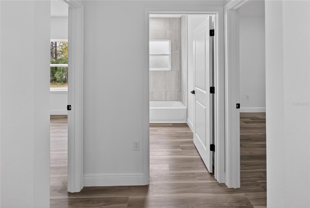 9066 North Akola Way Citrus Springs, FL 34434 - Photo 10 of 32 a view of a hallway with wooden floor and entryway
